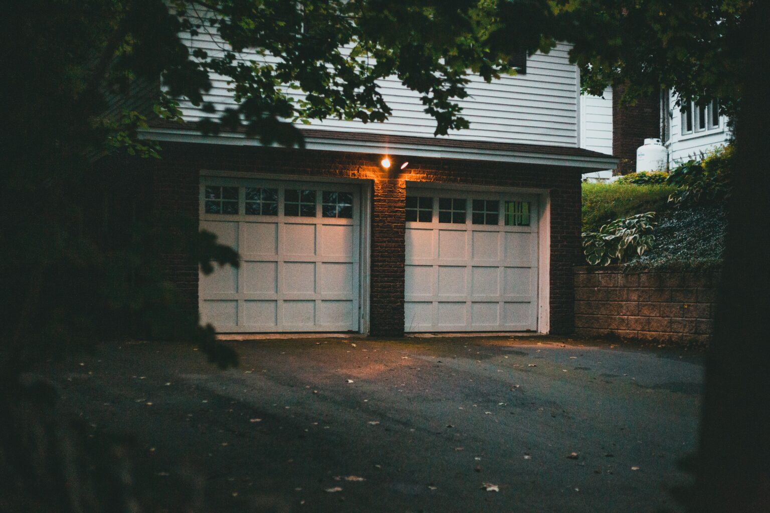 Garage door lit at dusk on a home in Pierce County, Washington